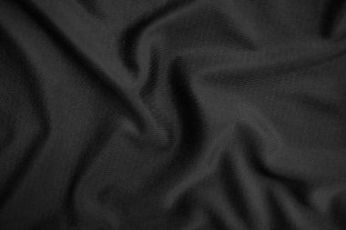Arkaplan dokusu siyah kumaş. Soyut koyu dalgalı yumuşak. Kumaş kırışmış. Lüks moda tarzı..