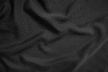 Arkaplan dokusu siyah kumaş. Soyut koyu dalgalı yumuşak. Kumaş kırışmış. Lüks moda tarzı..