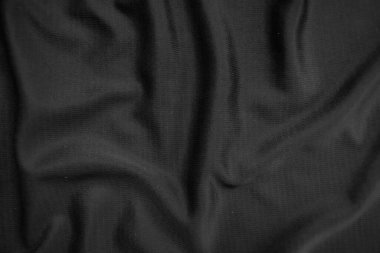 Arkaplan dokusu siyah kumaş. Soyut koyu dalgalı yumuşak. Kumaş kırışmış. Lüks moda tarzı..