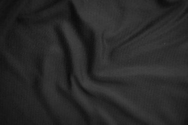 Arkaplan dokusu siyah kumaş. Soyut koyu dalgalı yumuşak. Kumaş kırışmış. Lüks moda tarzı..