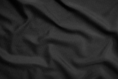Arkaplan dokusu siyah kumaş. Soyut koyu dalgalı yumuşak. Kumaş kırışmış. Lüks moda tarzı..