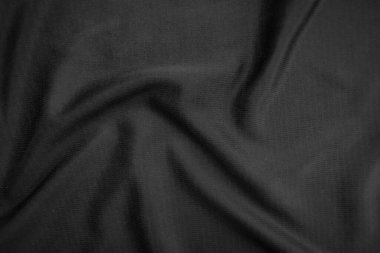 Arkaplan dokusu siyah kumaş. Soyut koyu dalgalı yumuşak. Kumaş kırışmış. Lüks moda tarzı..