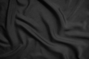Arkaplan dokusu siyah kumaş. Soyut koyu dalgalı yumuşak. Kumaş kırışmış. Lüks moda tarzı..