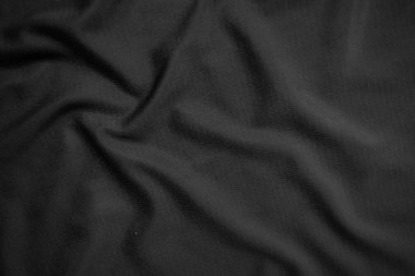 Arkaplan dokusu siyah kumaş. Soyut koyu dalgalı yumuşak. Kumaş kırışmış. Lüks moda tarzı..