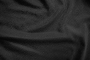 Arkaplan dokusu siyah kumaş. Soyut koyu dalgalı yumuşak. Kumaş kırışmış. Lüks moda tarzı..