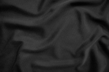 Arkaplan dokusu siyah kumaş. Soyut koyu dalgalı yumuşak. Kumaş kırışmış. Lüks moda tarzı..