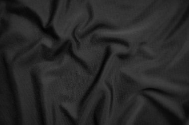 Arkaplan dokusu siyah kumaş. Soyut koyu dalgalı yumuşak. Kumaş kırışmış. Lüks moda tarzı..