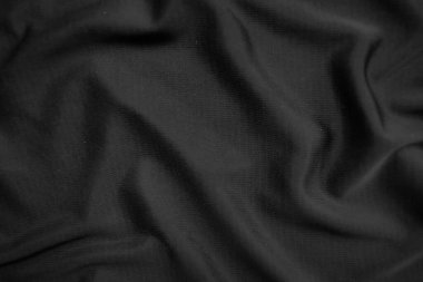 Arkaplan dokusu siyah kumaş. Soyut koyu dalgalı yumuşak. Kumaş kırışmış. Lüks moda tarzı..