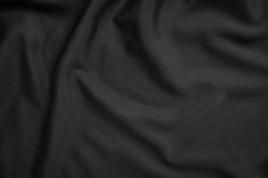 Arkaplan dokusu siyah kumaş. Soyut koyu dalgalı yumuşak. Kumaş kırışmış. Lüks moda tarzı..