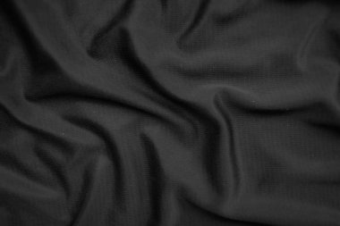 Arkaplan dokusu siyah kumaş. Soyut koyu dalgalı yumuşak. Kumaş kırışmış. Lüks moda tarzı..