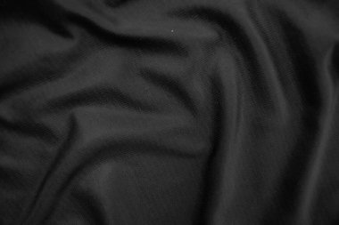 Arkaplan dokusu siyah kumaş. Soyut koyu dalgalı yumuşak. Kumaş kırışmış. Lüks moda tarzı..