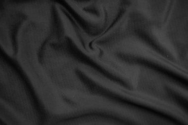 Arkaplan dokusu siyah kumaş. Soyut koyu dalgalı yumuşak. Kumaş kırışmış. Lüks moda tarzı..
