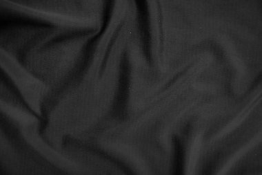 Arkaplan dokusu siyah kumaş. Soyut koyu dalgalı yumuşak. Kumaş kırışmış. Lüks moda tarzı..