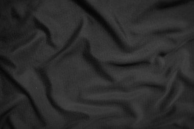 Arkaplan dokusu siyah kumaş. Soyut koyu dalgalı yumuşak. Kumaş kırışmış. Lüks moda tarzı..