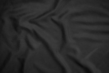 Arkaplan dokusu siyah kumaş. Soyut koyu dalgalı yumuşak. Kumaş kırışmış. Lüks moda tarzı..
