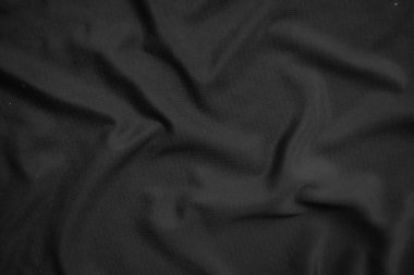 Arkaplan dokusu siyah kumaş. Soyut koyu dalgalı yumuşak. Kumaş kırışmış. Lüks moda tarzı..