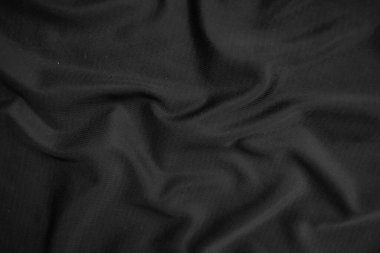 Arkaplan dokusu siyah kumaş. Soyut koyu dalgalı yumuşak. Kumaş kırışmış. Lüks moda tarzı..