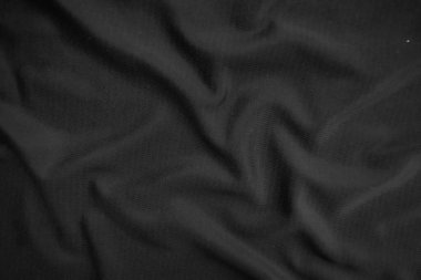 Arkaplan dokusu siyah kumaş. Soyut koyu dalgalı yumuşak. Kumaş kırışmış. Lüks moda tarzı..