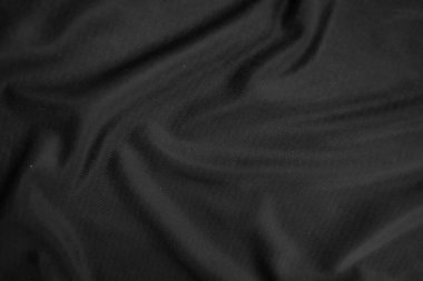 Arkaplan dokusu siyah kumaş. Soyut koyu dalgalı yumuşak. Kumaş kırışmış. Lüks moda tarzı..