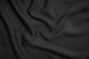 Arkaplan dokusu siyah kumaş. Soyut koyu dalgalı yumuşak. Kumaş kırışmış. Lüks moda tarzı..