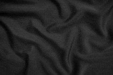 Arkaplan dokusu siyah kumaş. Soyut koyu dalgalı yumuşak. Kumaş kırışmış. Lüks moda tarzı..