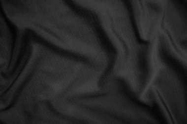 Arkaplan dokusu siyah kumaş. Soyut koyu dalgalı yumuşak. Kumaş kırışmış. Lüks moda tarzı..
