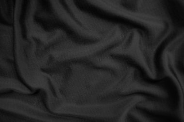Arkaplan dokusu siyah kumaş. Soyut koyu dalgalı yumuşak. Kumaş kırışmış. Lüks moda tarzı..