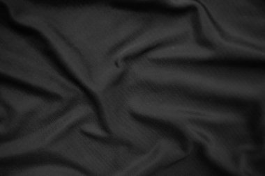 Arkaplan dokusu siyah kumaş. Soyut koyu dalgalı yumuşak. Kumaş kırışmış. Lüks moda tarzı..