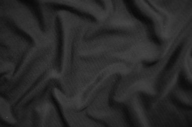 Arkaplan dokusu siyah kumaş. Soyut koyu dalgalı yumuşak. Kumaş kırışmış. Lüks moda tarzı..