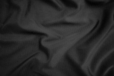 Arkaplan dokusu siyah kumaş. Soyut koyu dalgalı yumuşak. Kumaş kırışmış. Lüks moda tarzı..