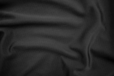 Arkaplan dokusu siyah kumaş. Soyut koyu dalgalı yumuşak. Kumaş kırışmış. Lüks moda tarzı..
