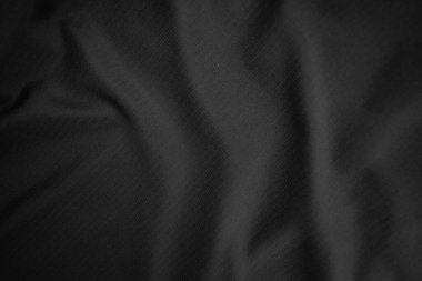 Arkaplan dokusu siyah kumaş. Soyut koyu dalgalı yumuşak. Kumaş kırışmış. Lüks moda tarzı..