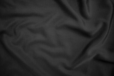 Arkaplan dokusu siyah kumaş. Soyut koyu dalgalı yumuşak. Kumaş kırışmış. Lüks moda tarzı..
