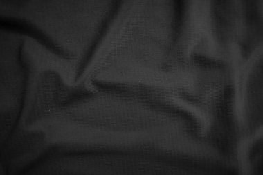 Arkaplan dokusu siyah kumaş. Soyut koyu dalgalı yumuşak. Kumaş kırışmış. Lüks moda tarzı..