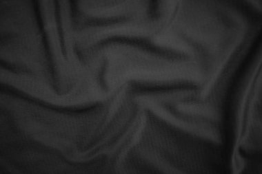 Arkaplan dokusu siyah kumaş. Soyut koyu dalgalı yumuşak. Kumaş kırışmış. Lüks moda tarzı..