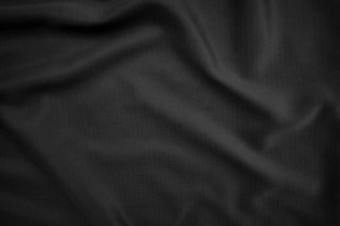 Arkaplan dokusu siyah kumaş. Soyut koyu dalgalı yumuşak. Kumaş kırışmış. Lüks moda tarzı..