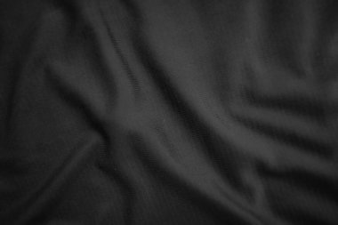 Arkaplan dokusu siyah kumaş. Soyut koyu dalgalı yumuşak. Kumaş kırışmış. Lüks moda tarzı..