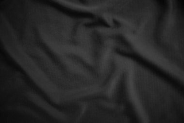 Arkaplan dokusu siyah kumaş. Soyut koyu dalgalı yumuşak. Kumaş kırışmış. Lüks moda tarzı..