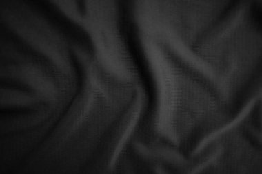 Arkaplan dokusu siyah kumaş. Soyut koyu dalgalı yumuşak. Kumaş kırışmış. Lüks moda tarzı..