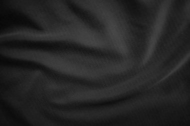 Arkaplan dokusu siyah kumaş. Soyut koyu dalgalı yumuşak. Kumaş kırışmış. Lüks moda tarzı..