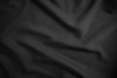 Arkaplan dokusu siyah kumaş. Soyut koyu dalgalı yumuşak. Kumaş kırışmış. Lüks moda tarzı..
