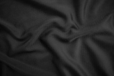 Arkaplan dokusu siyah kumaş. Soyut koyu dalgalı yumuşak. Kumaş kırışmış. Lüks moda tarzı..