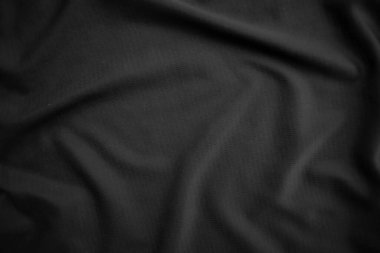 Arkaplan dokusu siyah kumaş. Soyut koyu dalgalı yumuşak. Kumaş kırışmış. Lüks moda tarzı..