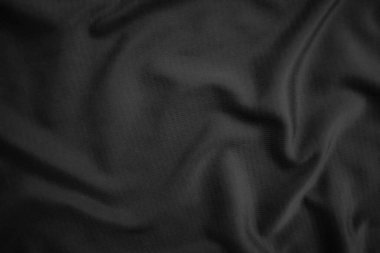 Arkaplan dokusu siyah kumaş. Soyut koyu dalgalı yumuşak. Kumaş kırışmış. Lüks moda tarzı..