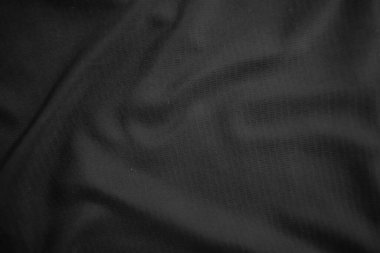 Arkaplan dokusu siyah kumaş. Soyut koyu dalgalı yumuşak. Kumaş kırışmış. Lüks moda tarzı..