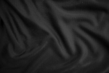 Arkaplan dokusu siyah kumaş. Soyut koyu dalgalı yumuşak. Kumaş kırışmış. Lüks moda tarzı..