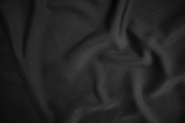 Arkaplan dokusu siyah kumaş. Soyut koyu dalgalı yumuşak. Kumaş kırışmış. Lüks moda tarzı..
