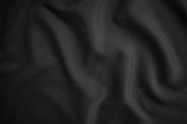 Arkaplan dokusu siyah kumaş. Soyut koyu dalgalı yumuşak. Kumaş kırışmış. Lüks moda tarzı..