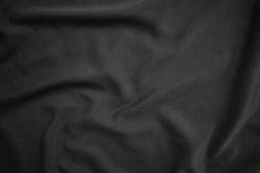 Arkaplan dokusu siyah kumaş. Soyut koyu dalgalı yumuşak. Kumaş kırışmış. Lüks moda tarzı..