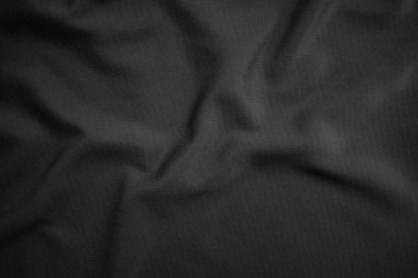 Arkaplan dokusu siyah kumaş. Soyut koyu dalgalı yumuşak. Kumaş kırışmış. Lüks moda tarzı..